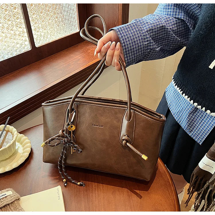 PU leather shoulder bag for women, brown with top handles.