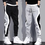 Men's patchwork jogger pants by Simples Market, two pairs in black/gray with white side panels, drawstring waist