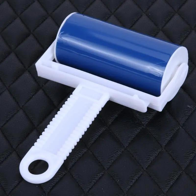 Handheld lint roller with a blue adhesive drum and white ergonomic handle.