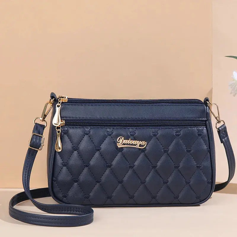 NovaLuxe PU Leather Messenger Bag For Women With Fur Ball Accent And Secure Zipper Closure