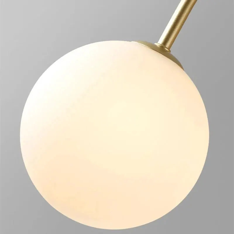 Nordic minimalist pendant light with frosted glass globe and brass stem