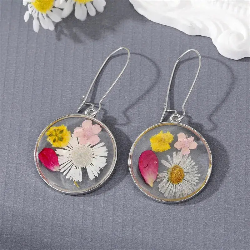 Pair of natural flower pressed resin dangle earrings, round clear pendants with colorful blooms and silver hooks
