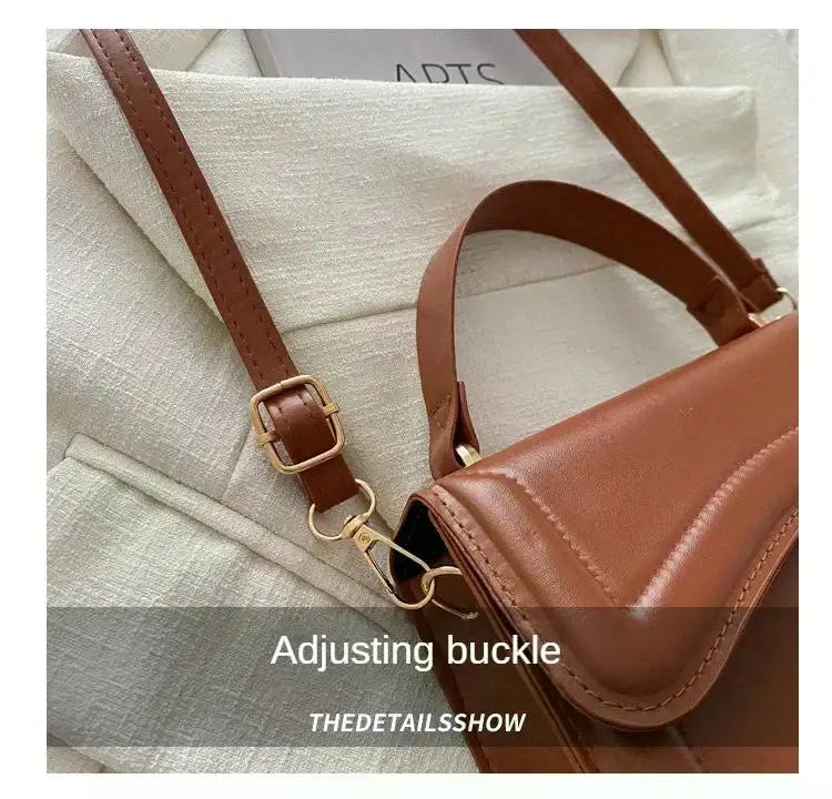 Brown PU leather handbag with adjustable strap and gold-tone hardware; crossbody tote.