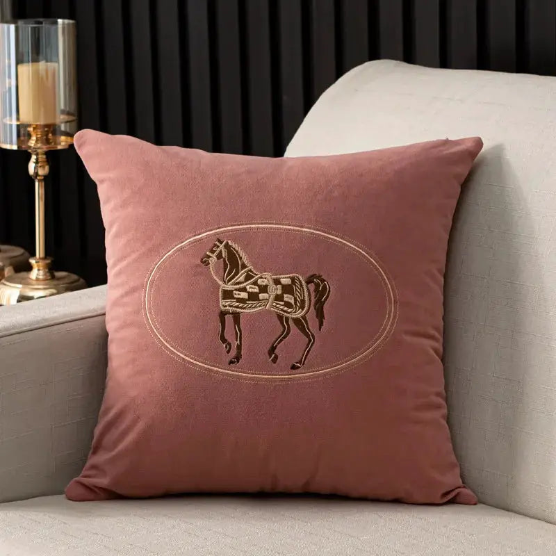 Cushion cover by Simples Market, pink with hand-embroidered horse design inside an oval, 45x45 cm.
