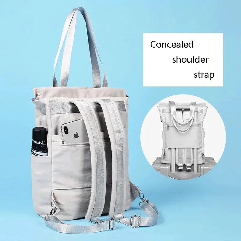 Womens waterproof laptop backpack in light gray canvas with concealed shoulder straps and side water bottle pocket
