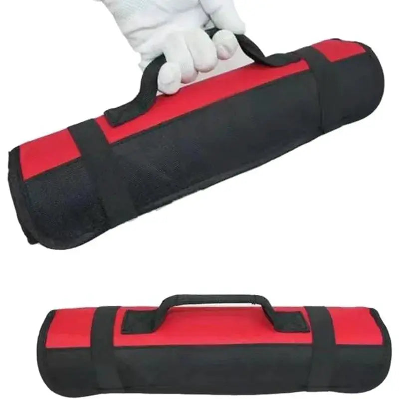 Roll tool bag in red and black heavy-duty nylon with a carry handle for portable folding tool storage