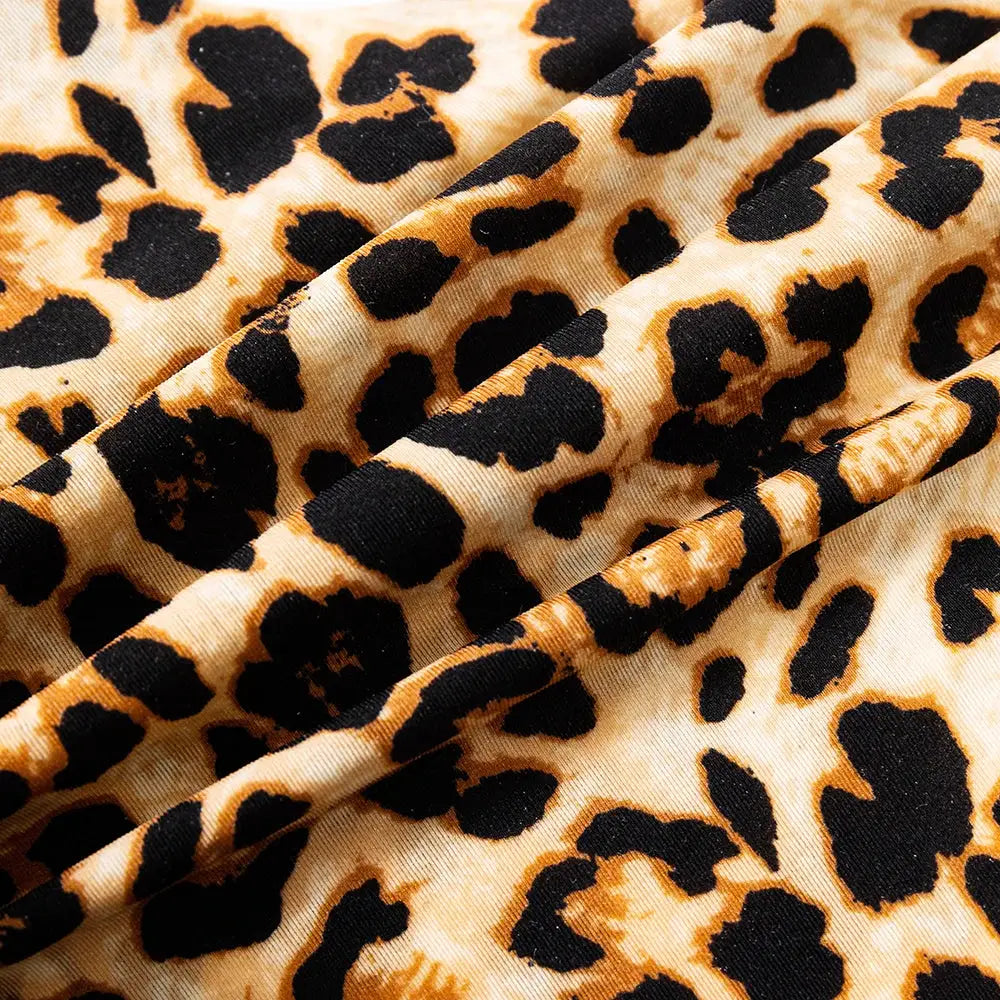Leopard print ice-silk fabric close-up with beige background and black spots, ideal for sexy women's underwear.