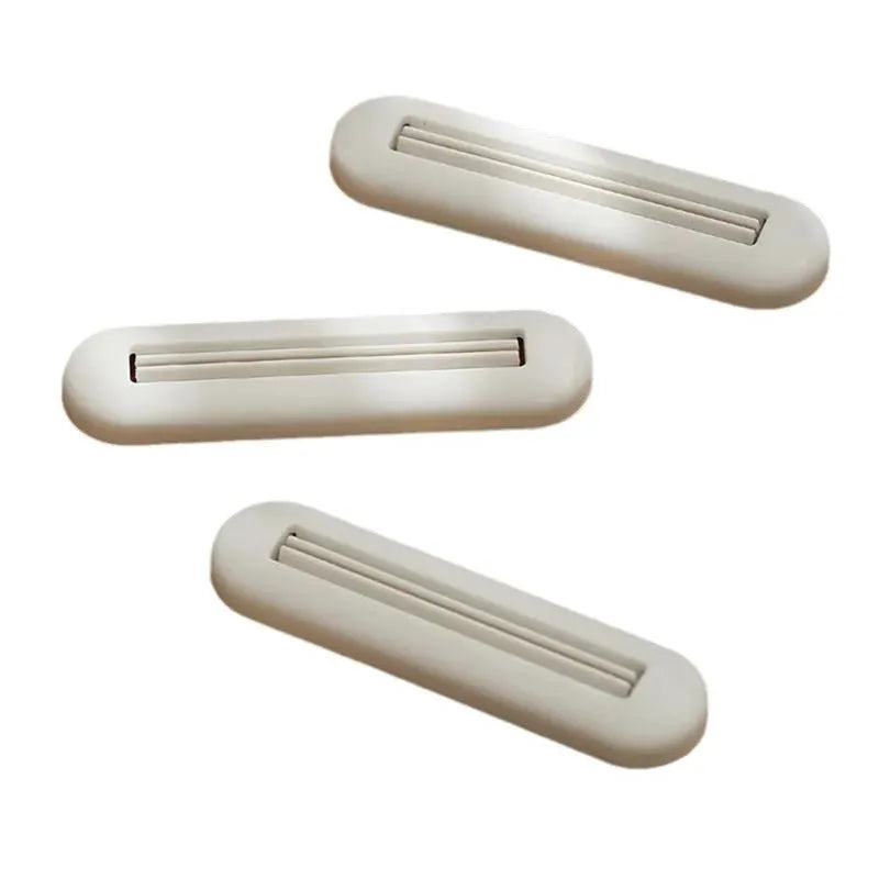 Toothpaste squeezer set of 3; white plastic rolling squeezers by Simples Market.