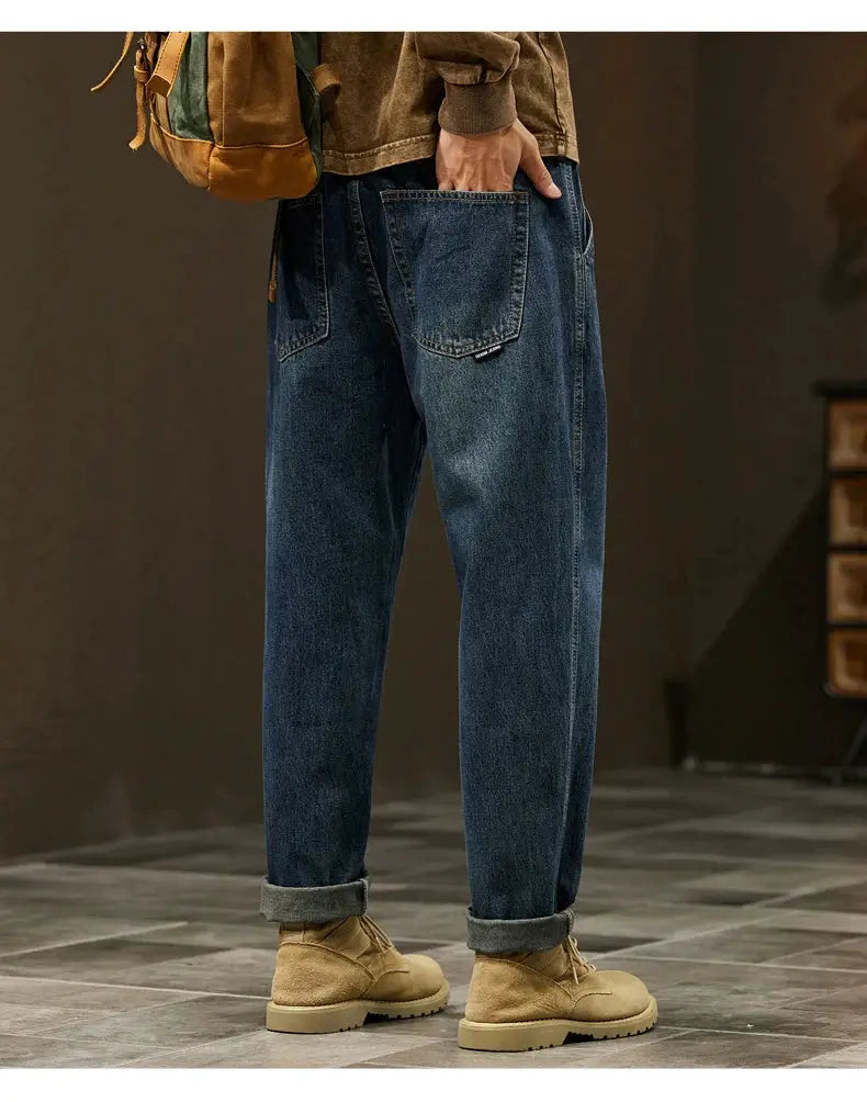 Men's loose-fit baggy denim jeans in blue with rolled cuffs