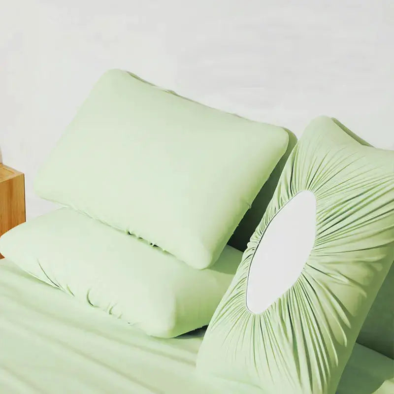 Disposable green pillowcases; three shown for travel and hotel use
