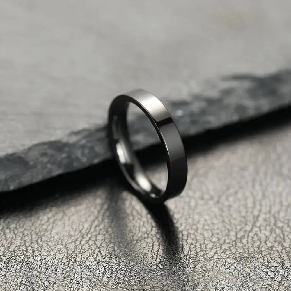 Unisex stainless steel ring with black matte finish, minimalist jewelry for men and women, for wedding or engagement.