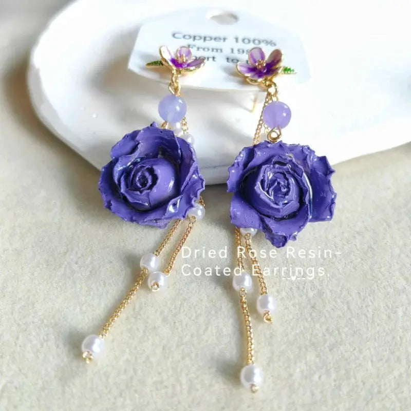 Elegant Immortal Rose epoxy resin long earrings with purple rose flowers, gold chains, and pearl drops (pair)
