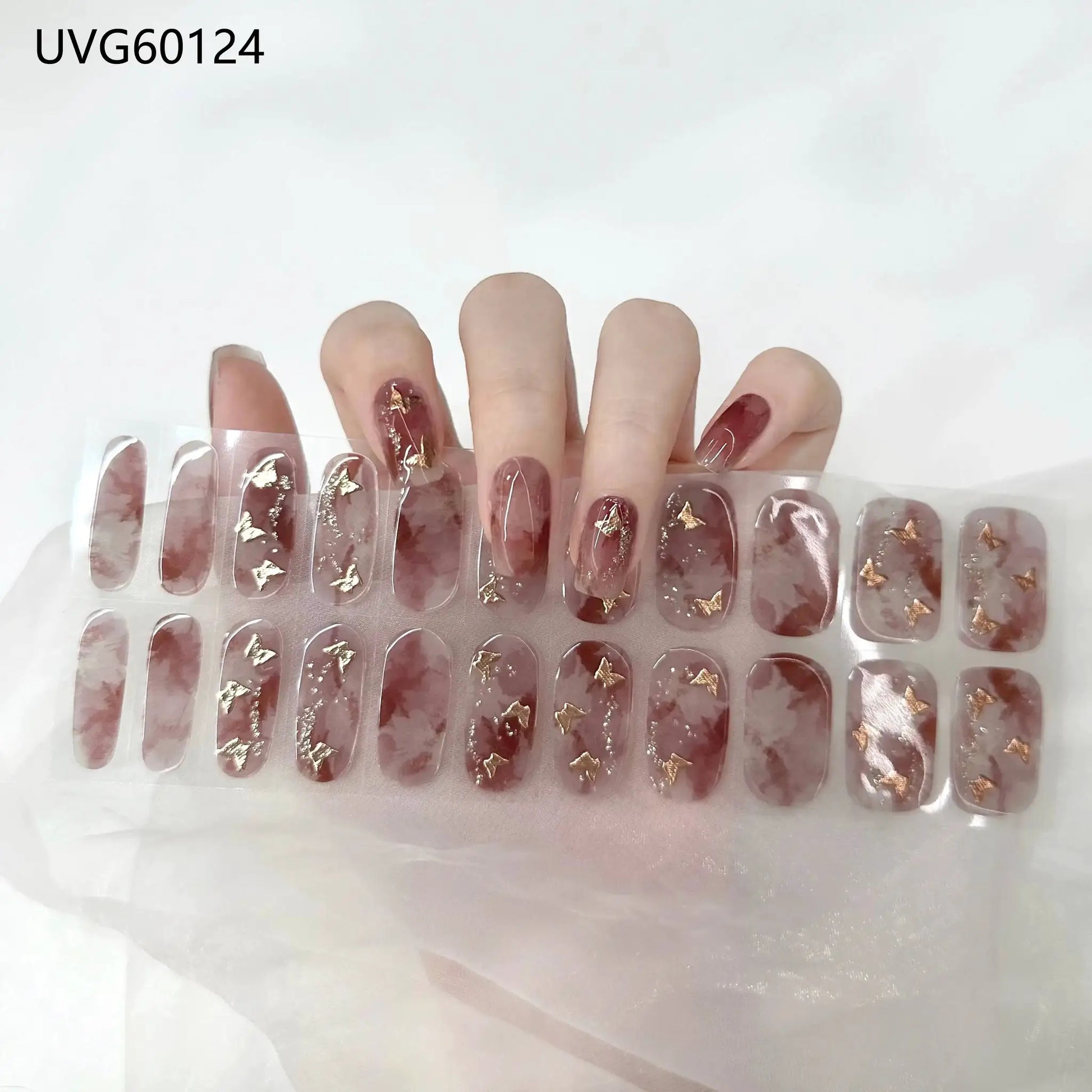 Gel nail wrap set by Simples Market; burgundy marble full-cover stickers with gold foil accents.