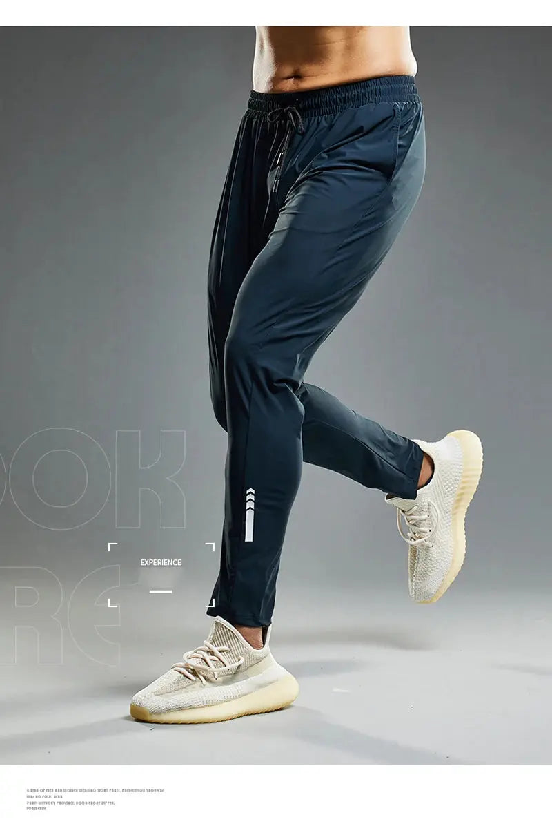 Summer elastic men's running pants in navy, with drawstring waist and tapered jogger fit.