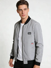Simples Market men's gray lightweight windbreaker with zip front, black ribbed collar and cuffs, chest logo patch.