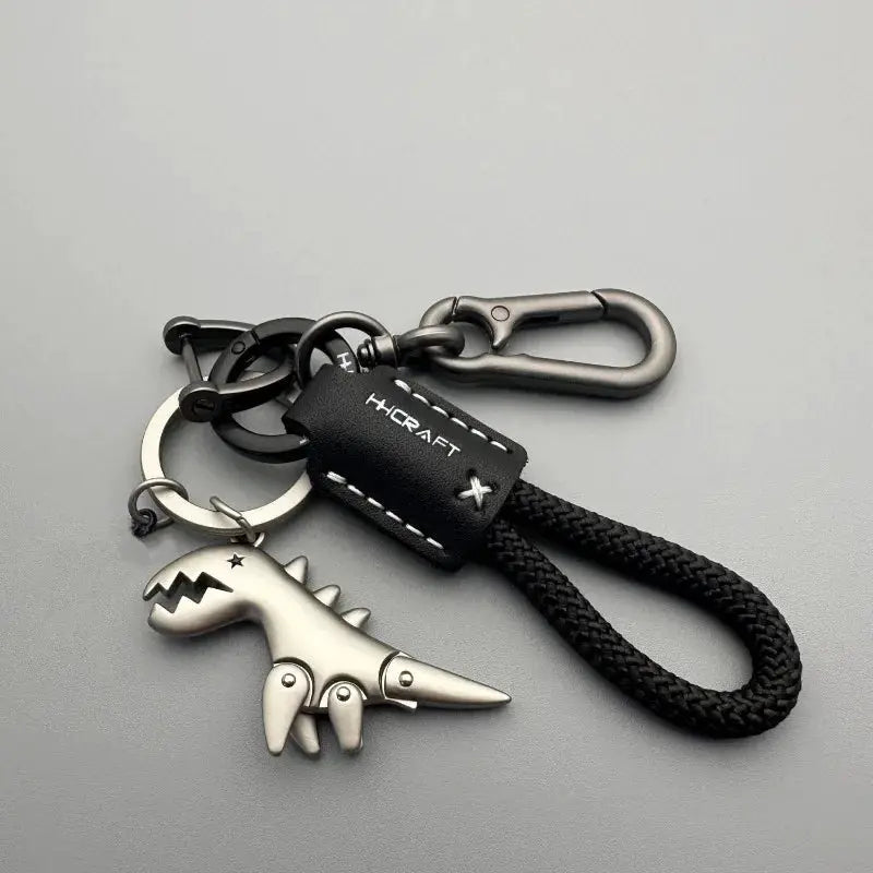 Motorcycle decoration keychain with black braided rope, metal carabiner, silver dinosaur pendant, and leather tag HCRAFT