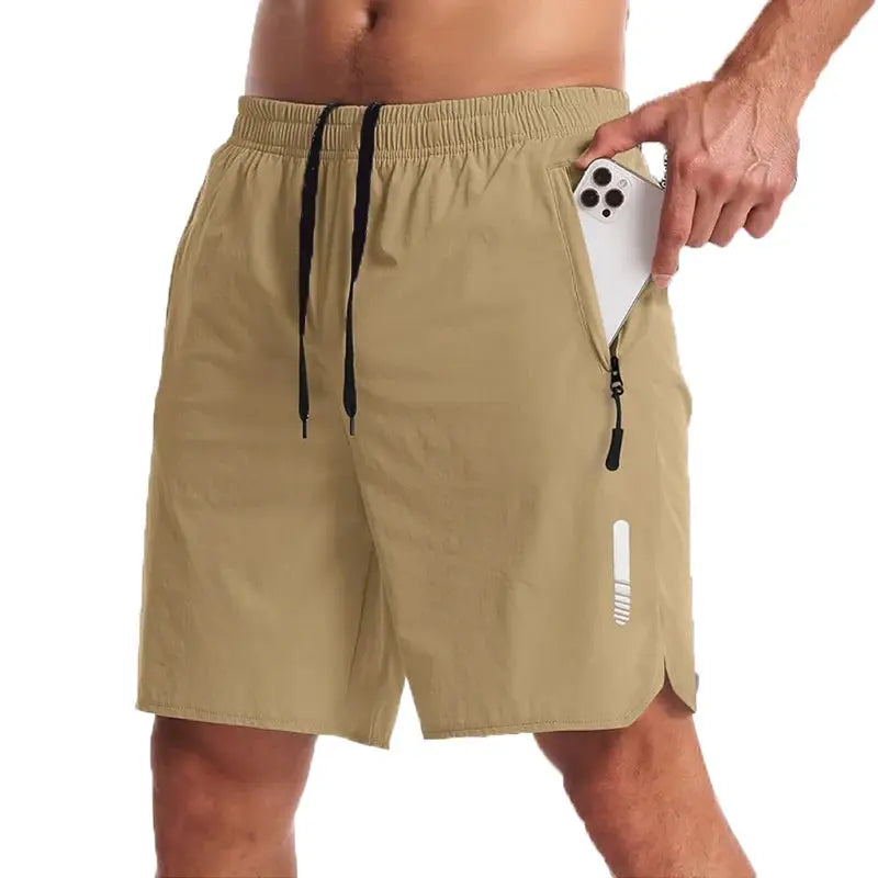 Men's Simples Market sport shorts, beige athletic shorts with black drawstring and side zip pocket holding phone
