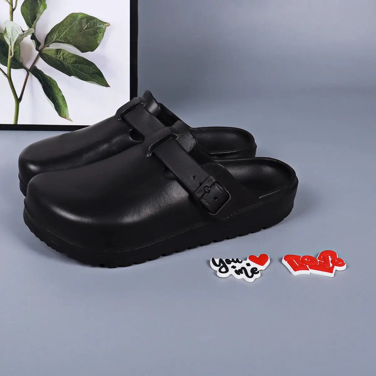 Black EVA slides with adjustable buckle straps for indoor/outdoor use, waterproof sandals