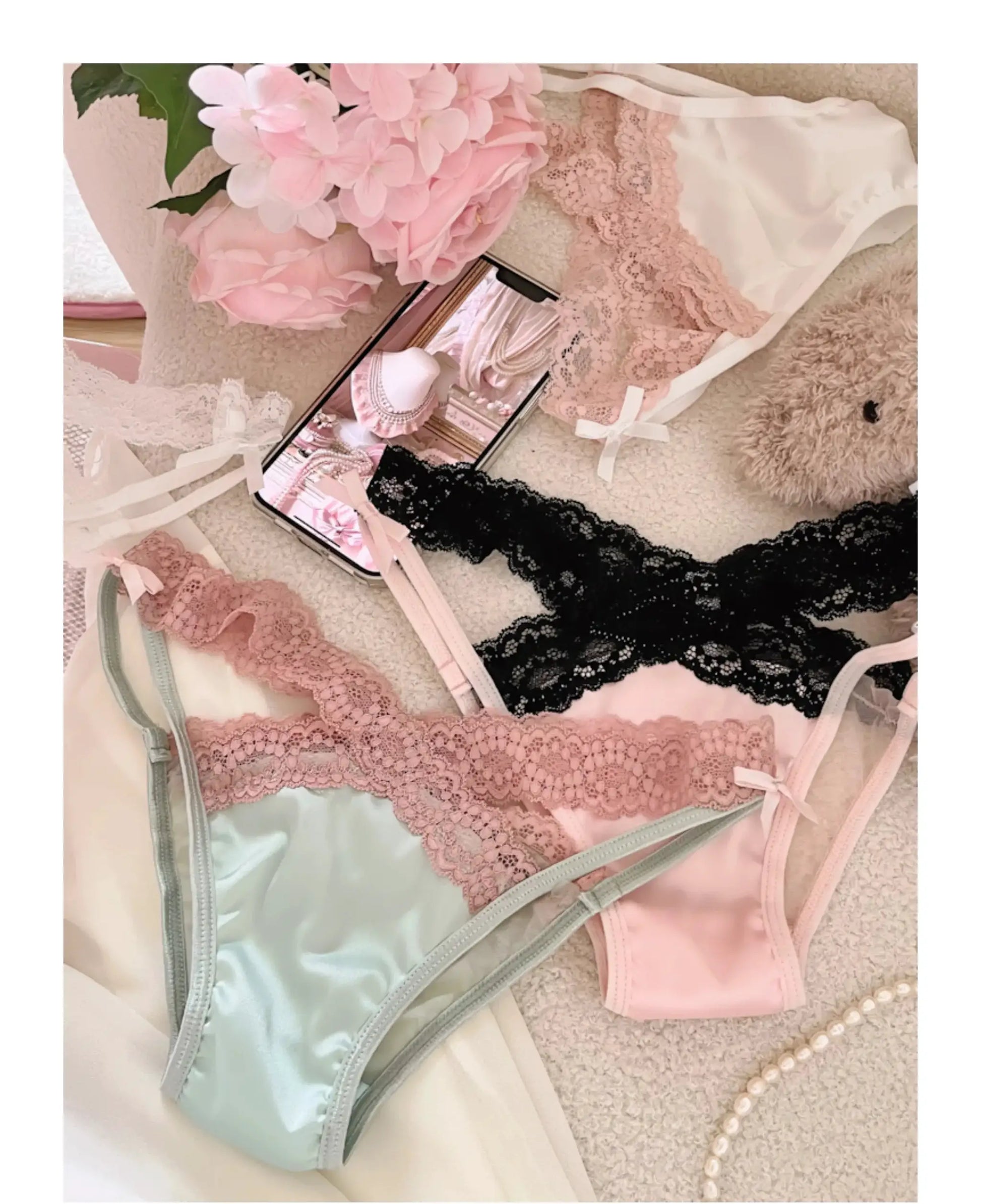 Lace lingerie set (4 pieces): pink, black lace and blue satin underwear with bow accents.