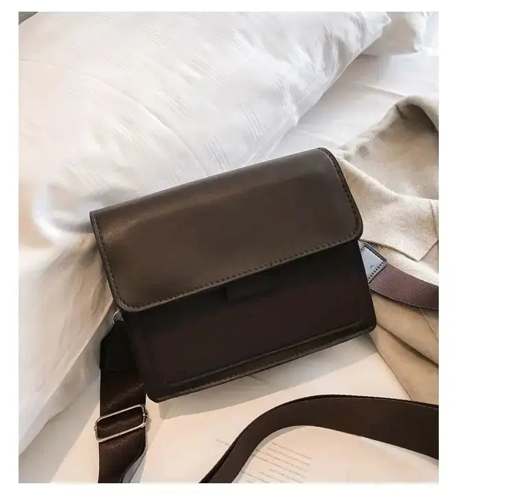 Crossbody bag in brown PU leather with front flap and adjustable strap
