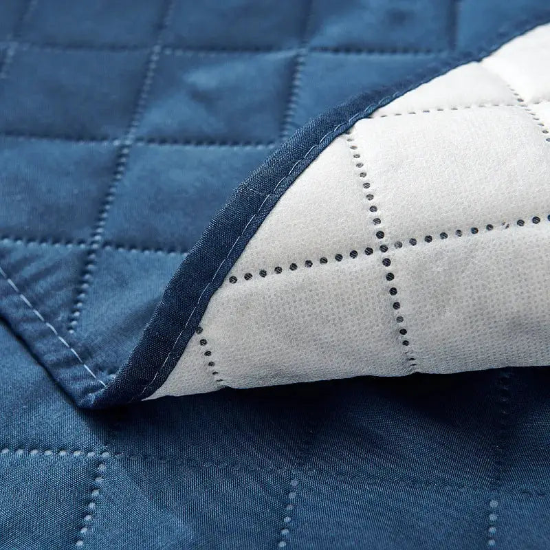 Recliner chair slipcover in solid blue quilted fabric with anti-slip design by Simples Market