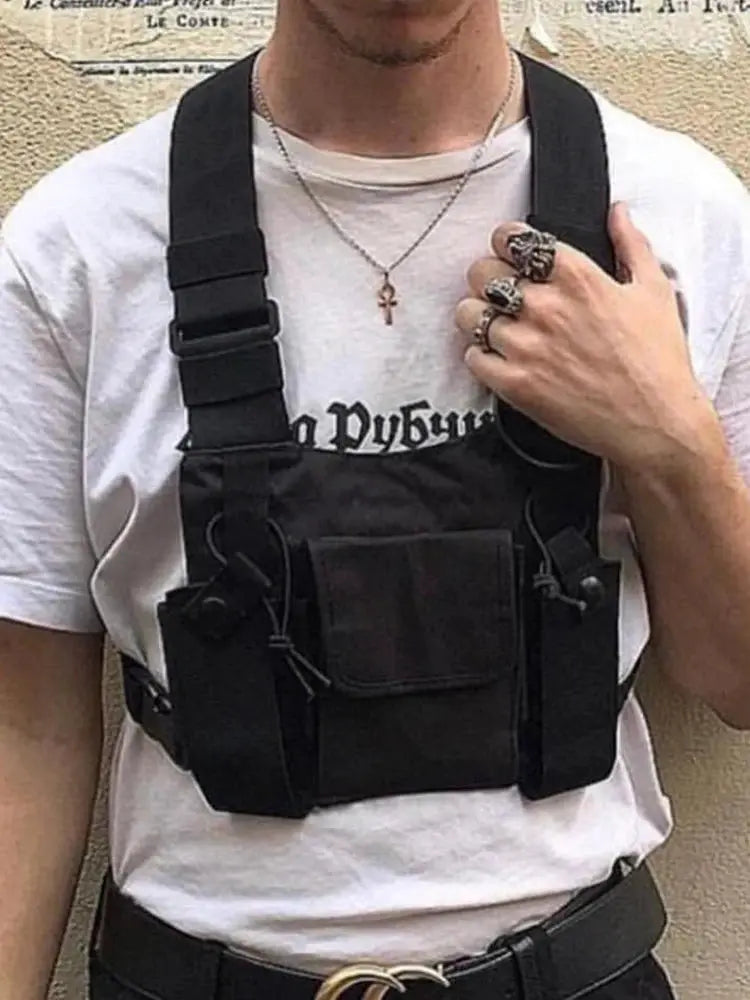 Functional tactical chest bag in black with front pocket and two side pouches worn over white tee