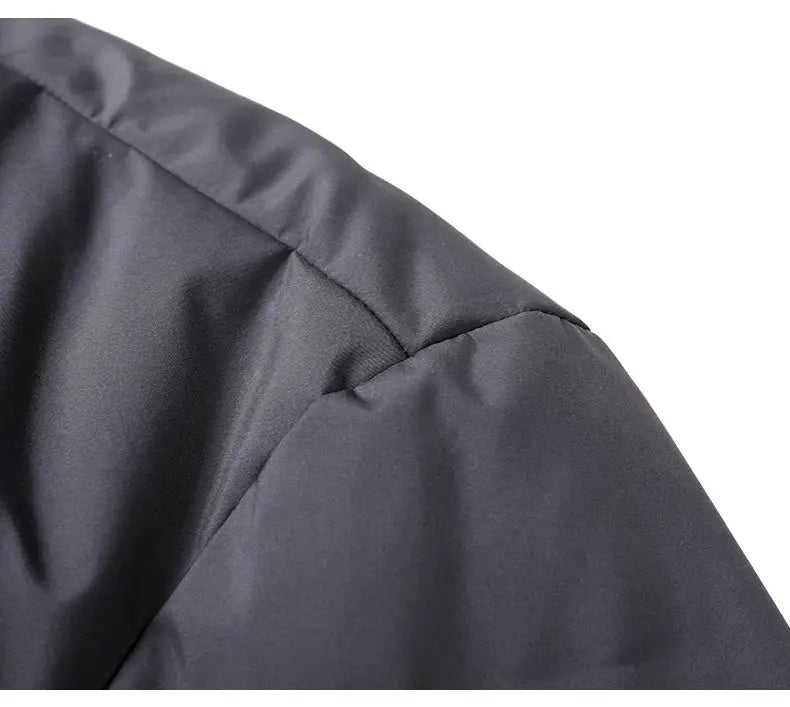 Men's down jacket shoulder close-up in dark gray fabric, padded quilted styling
