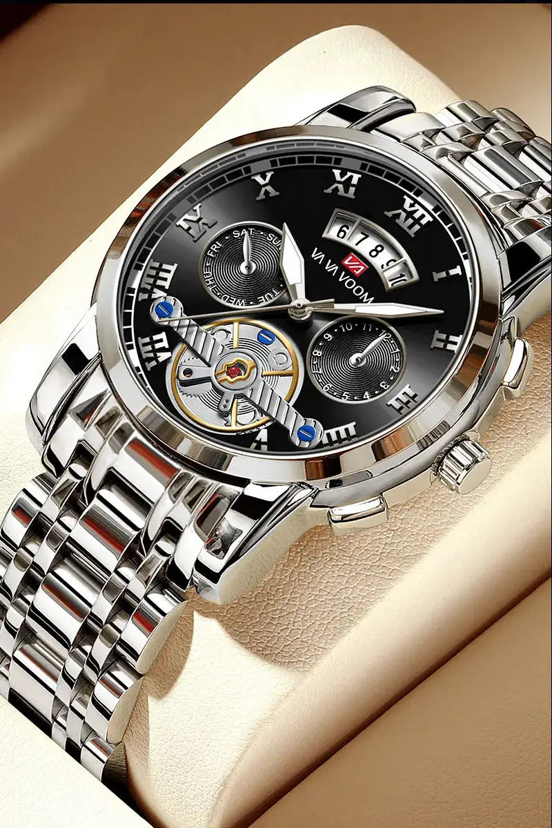 Men's stainless steel luxury watch with black dial, Roman numerals, skeleton movement and metal bracelet.