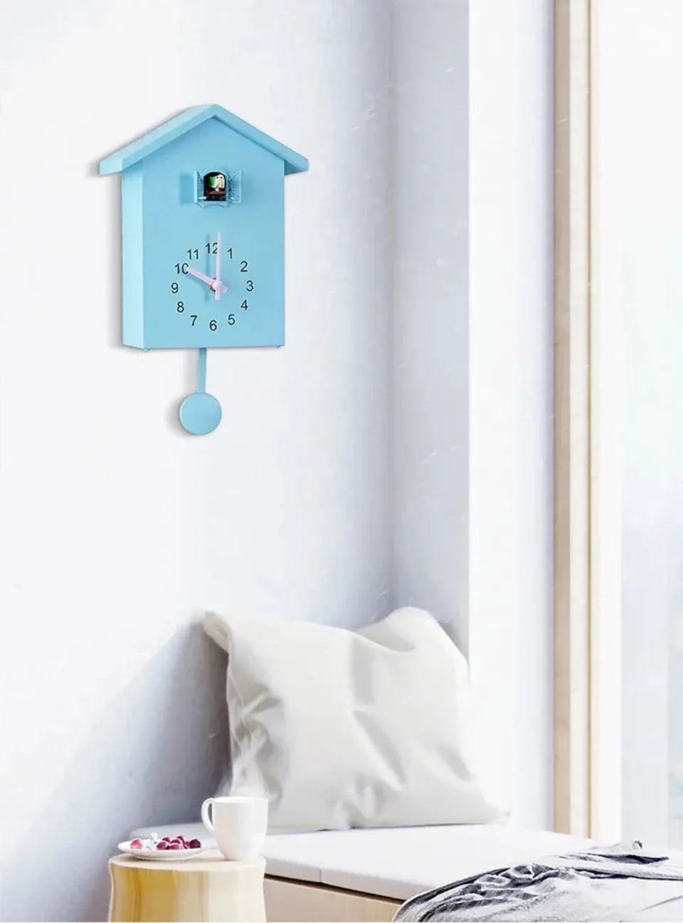 Blue cuckoo quartz wall clock by Simples Market, birdhouse-style with pendulum for living room or office.