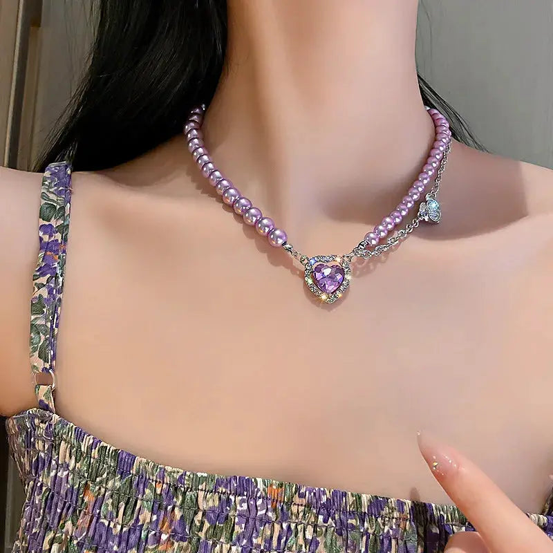 Kpop pearl choker necklace with purple beads and a heart-shaped purple pendant in gold-tone setting
