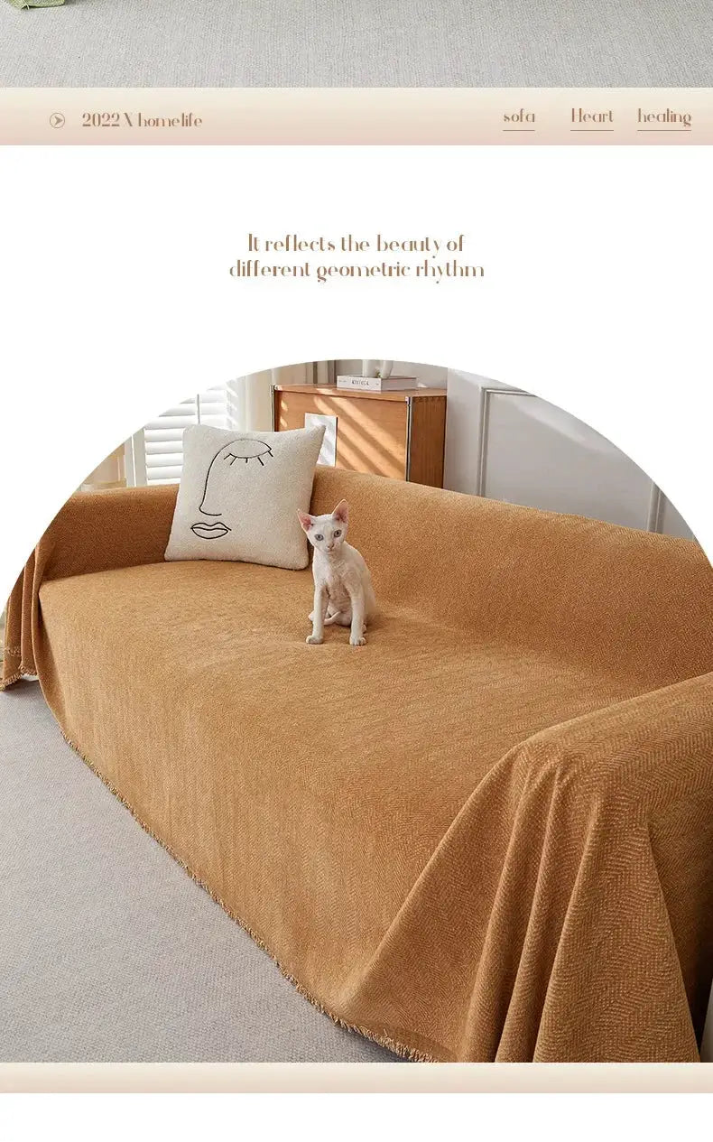 Sofa cover in warm tan chenille with fringe; heavyweight herringbone texture on couch