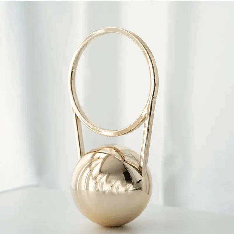 Evening clutch with gold ball handle and circular ring top, luxury bag