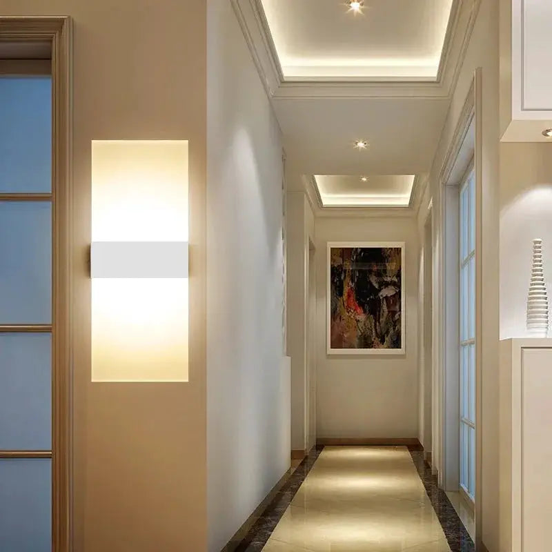 LED acrylic wall light by Simples Market; long vertical wall sconce with warm white glow for hallway