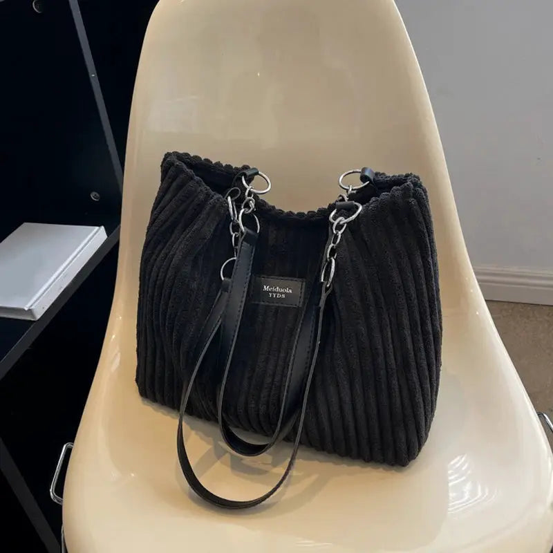Women corduroy shoulder bag in black with fixed shoulder strap and chain-link accents; large capacity casual bag