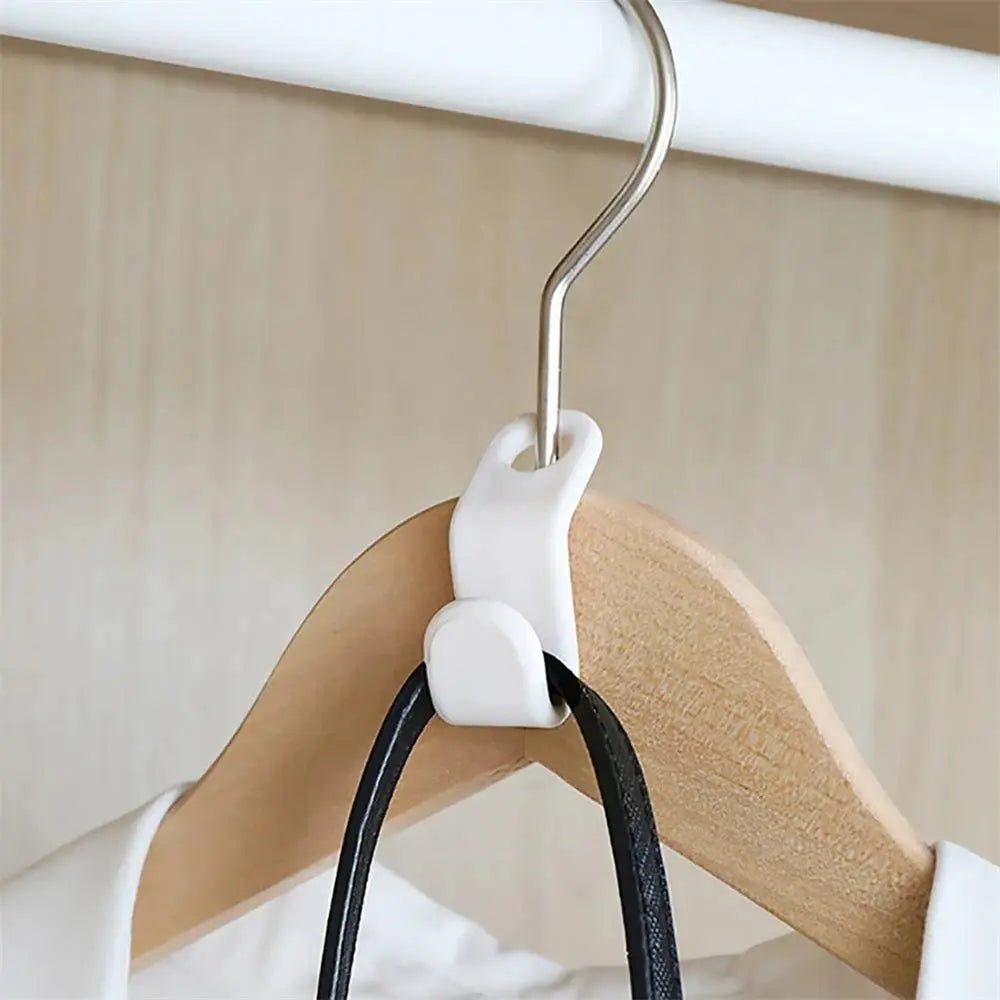 White plastic mini wardrobe hanger connector with metal hook on a clothes rod, cascading closet organizer