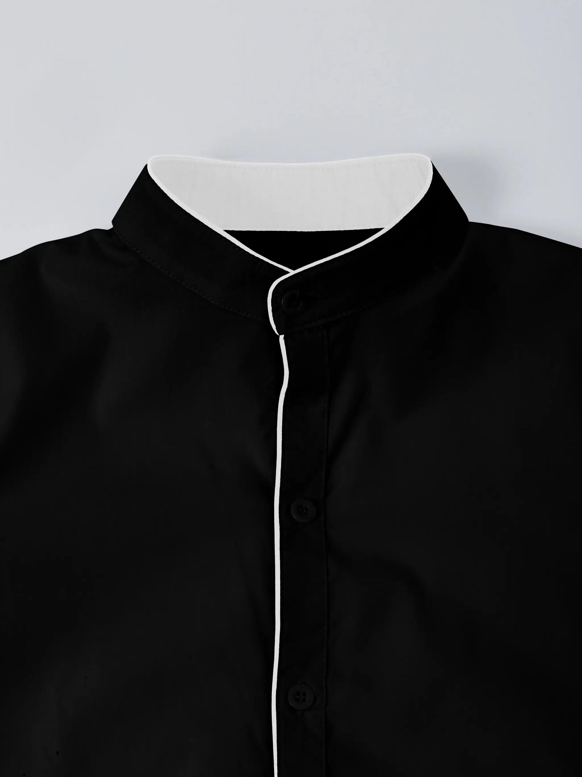 Men's black long-sleeve shirt with stand-up collar and white piping along front placket