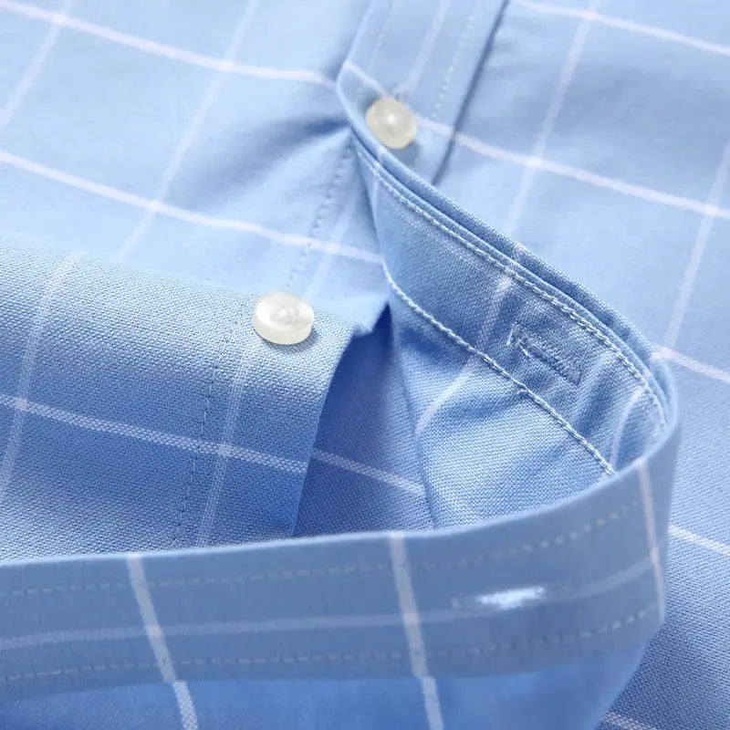 Men's blue oxford shirt with white plaid, 100% cotton, long sleeves with button cuffs.