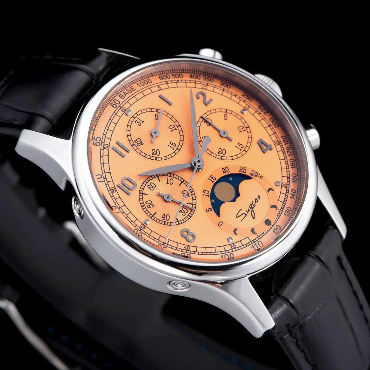 Sugess men's chronograph watch with orange dial, moonphase display, stainless steel case, and black leather strap.