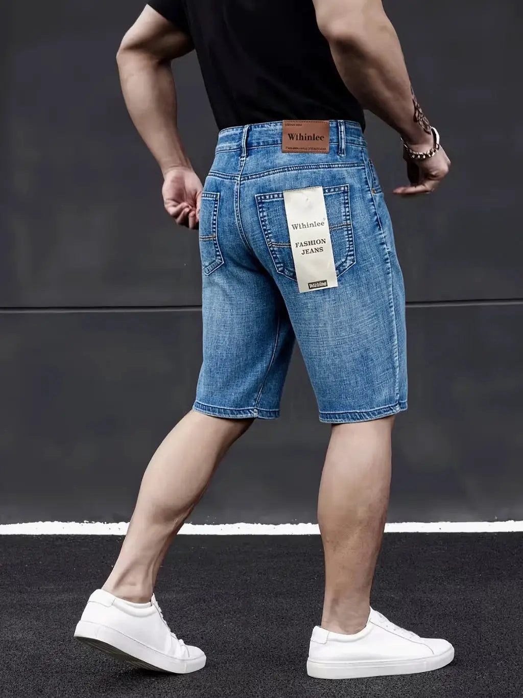 Mens blue denim knee-length shorts by Wthinlee with back pockets and hanging tag, shown with white sneakers
