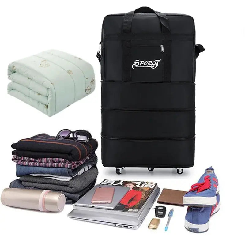 Black expandable wheeled travel luggage with SPORT logo; shown with clothes, blanket, shoes and a laptop.
