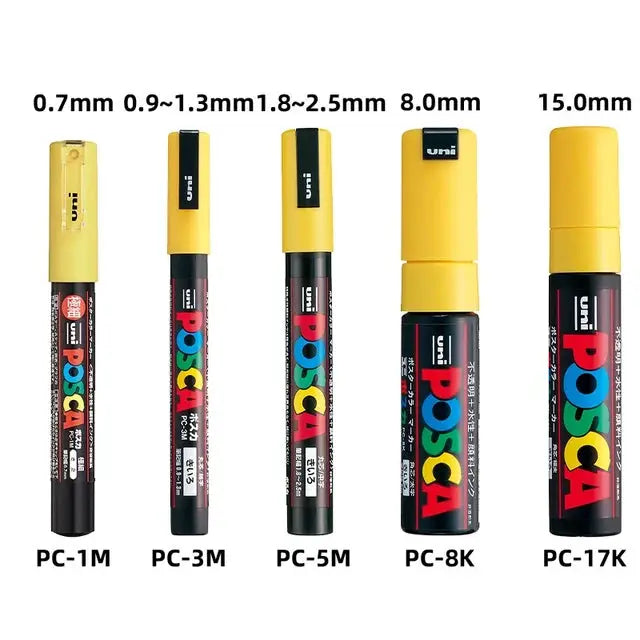Five Posca paint markers PC-1M PC-3M PC-5M PC-8K PC-17K with yellow caps and colorful POSCA logo on black bodies.