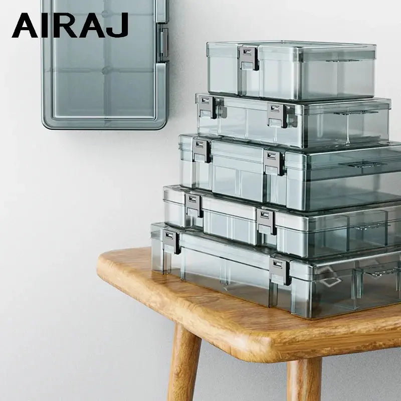 AIRAJ clear plastic tool-storage boxes set with metal latches, stacked on a wooden table.