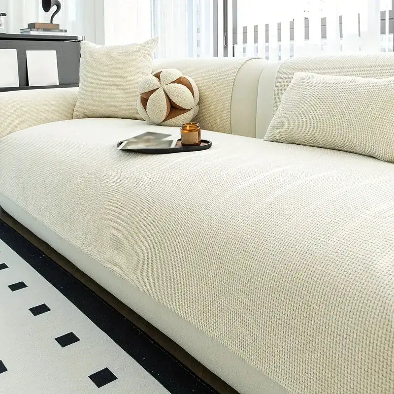 Minimalist solid weaving jacquard sofa cover in cream on a 3-seat couch with anti-slip design.