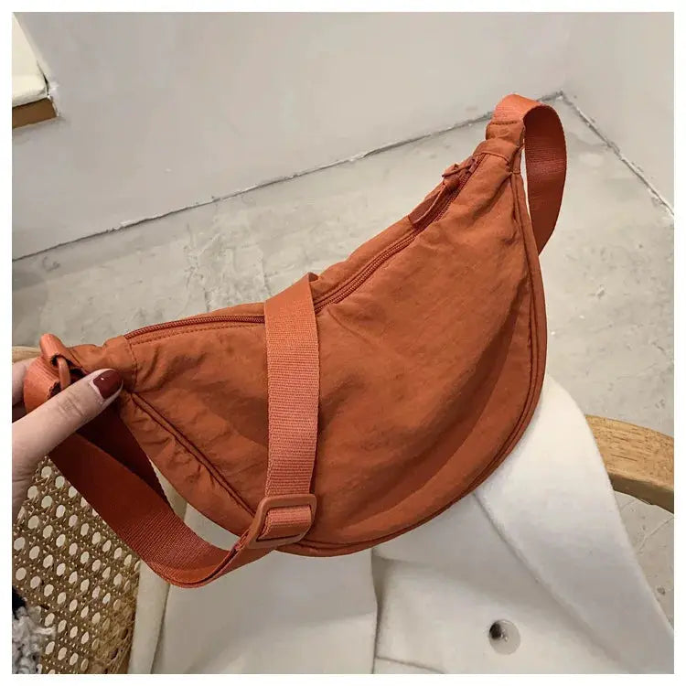 Casual nylon hobo crossbody bag in burnt orange with adjustable strap and top zipper