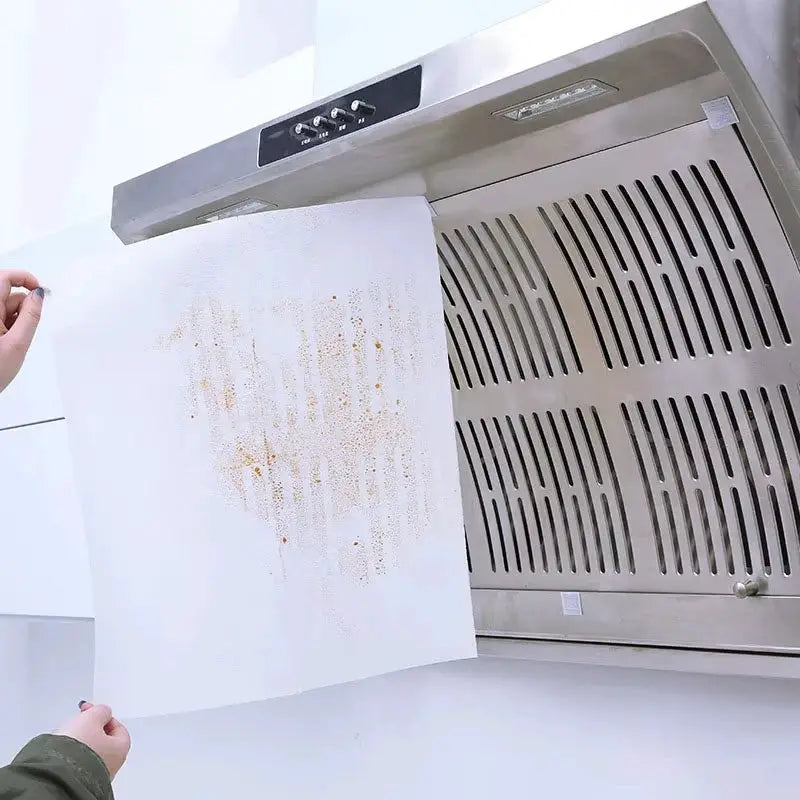 Simples Market disposable range hood filter paper, non-woven oil-proof sheet, 46cm, being removed from extractor hood.