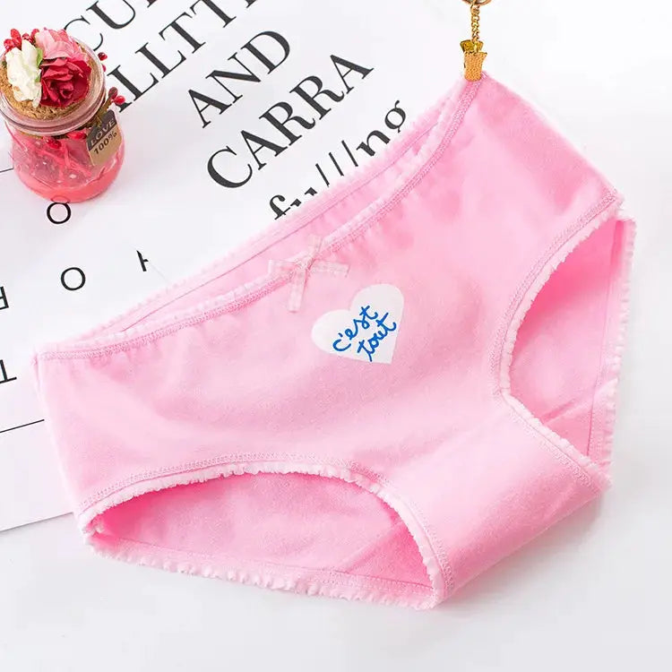 Pink cotton seamless women's panties with a small bow.