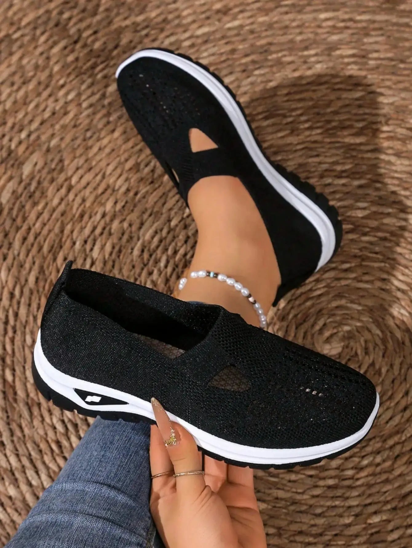Women's casual mesh sneakers with cut-out T-strap and cushioned wedge sole in black.