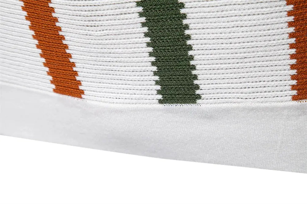 Polo shirt with ribbed knit texture and orange and green striped accents on white fabric.
