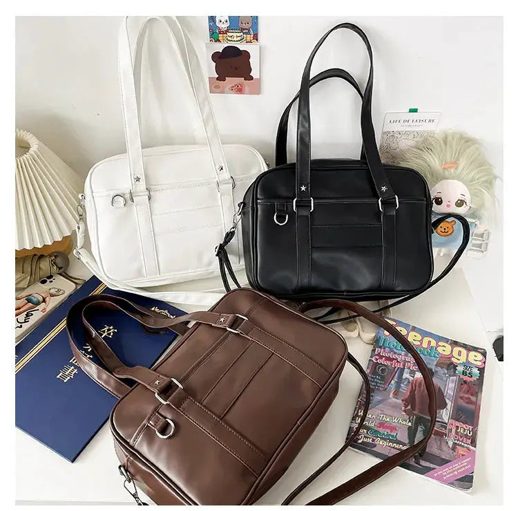 Three Japanese Style JK PU leather bags in white, black and brown with shoulder straps