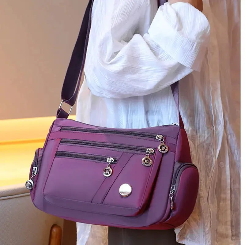 Ladies' purple nylon crossbody handbag with shoulder strap and multiple zip pockets by Simples Market